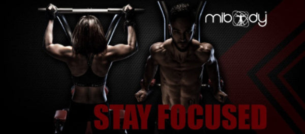 Two people exercising on pull-up bars with 'mibody' branding and 'Stay Focused' text.